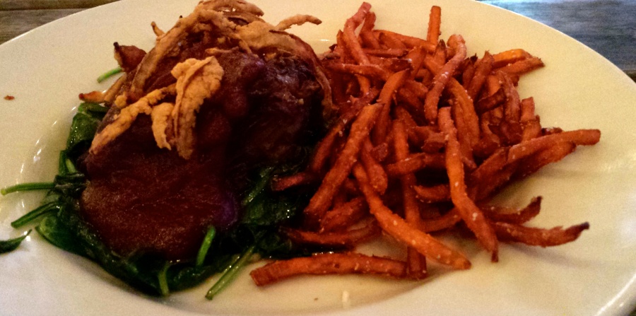 Beef short rib topped with pomegranate barbeque sauce and crispy fried onions, over a bed of sauteed spinach and sweet potato fries.